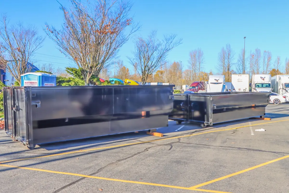 Professional dumpster rental service with roll-off container on residential driveway in New Carrollton